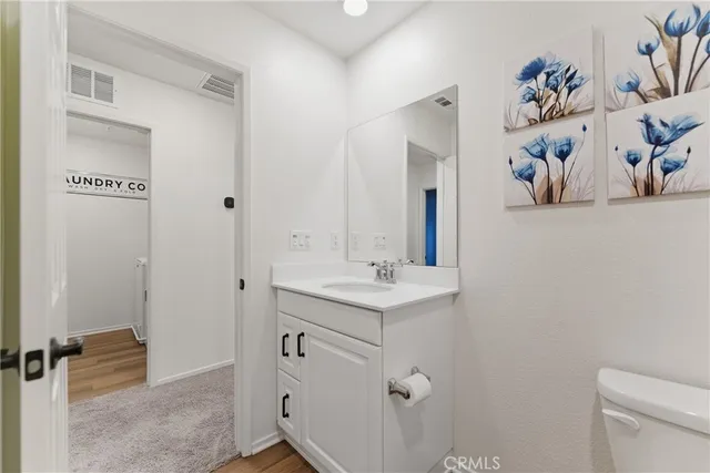 a bathroom with a sink a toilet and a mirror