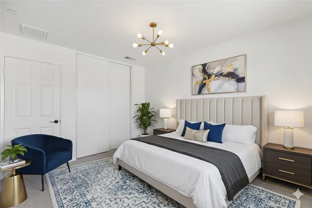 a bedroom with bed and a chandelier