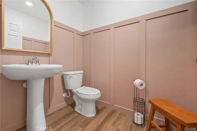 a bathroom with a sink toilet and a mirror