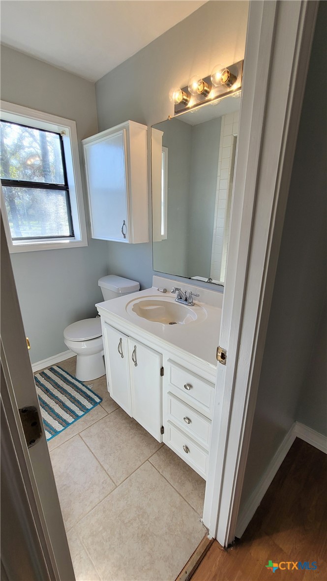 127-129 McAdams Road Goliad, TX 77963 - Photo 20 of 33 a bathroom with a double vanity sink and mirror