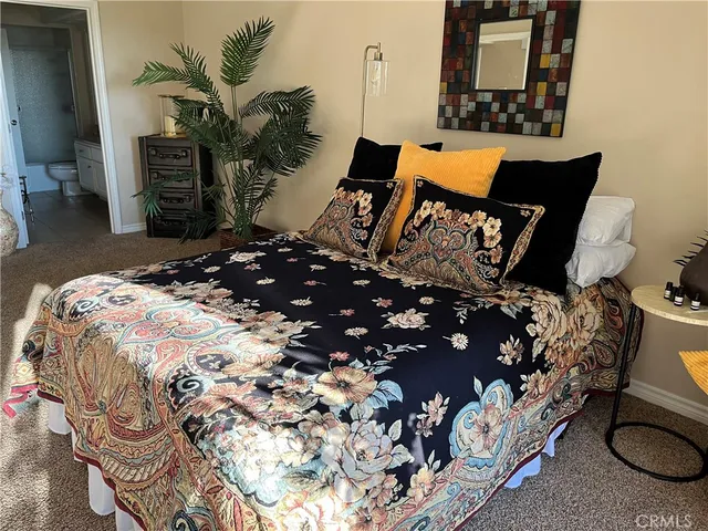 a bed sitting in a bedroom next to a window