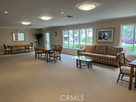 a kitchen with white cabinets and refrigerator