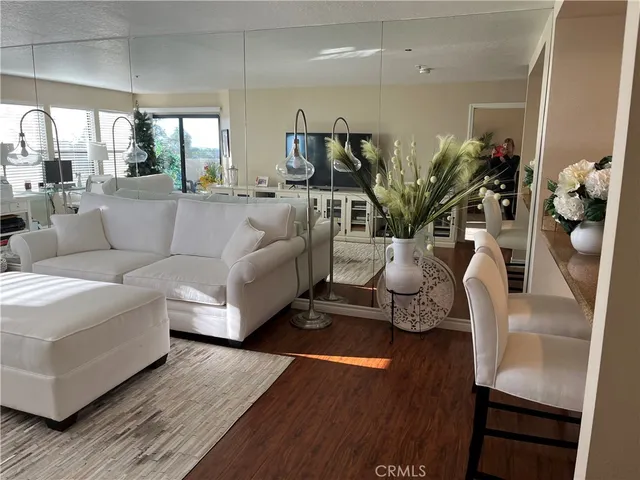 a living room with furniture potted plant and a large window