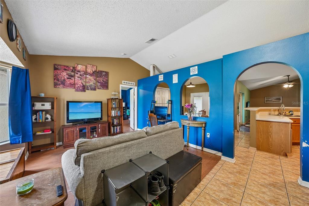 10303 Fordham Street Spring Hill, FL 34608 - Photo 4 of 25 a living room with fireplace furniture and flat screen tv