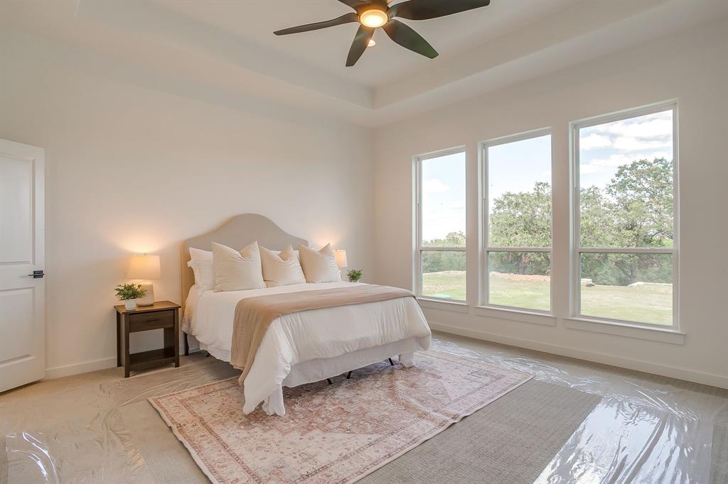 9012 Valley Oak Court Springtown, TX 76082 - Photo 28 of 40 a bedroom with a bed and window