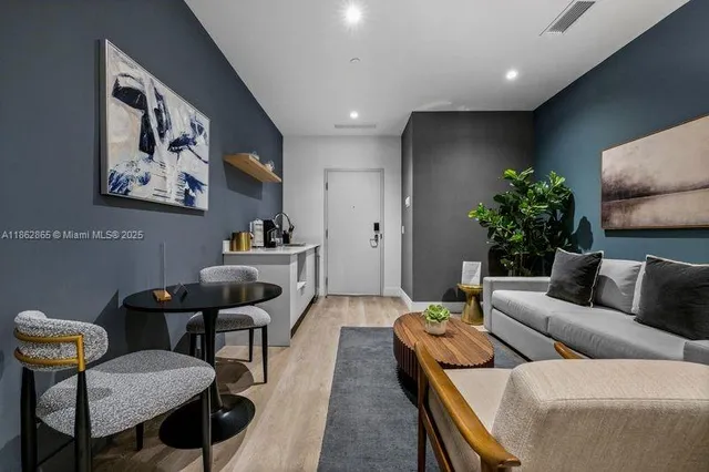 a living room with furniture and a potted plant