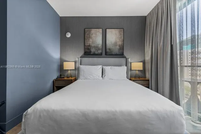 a bedroom with a bed and window