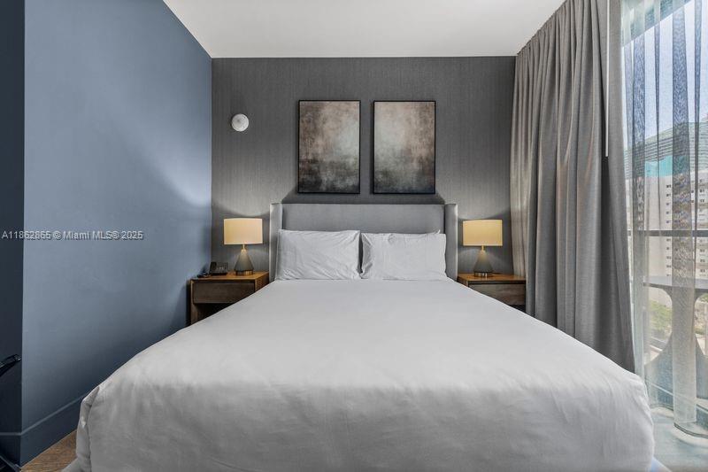 239 Southwest 9th Street, Unit 602 Miami, FL 33130 - Photo 12 of 18 a bedroom with a bed and window