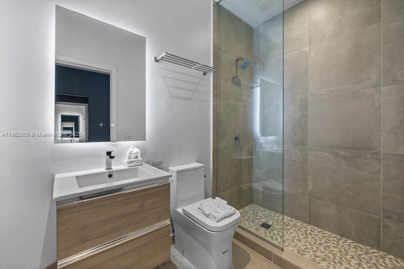 239 Southwest 9th Street, Unit 602 Miami, FL 33130 - Photo 14 of 18 a bathroom with a sink a toilet and shower