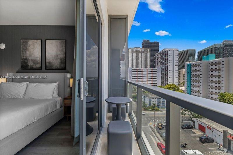 239 Southwest 9th Street, Unit 602 Miami, FL 33130 - Photo 16 of 18 a bedroom with furniture and a staircase