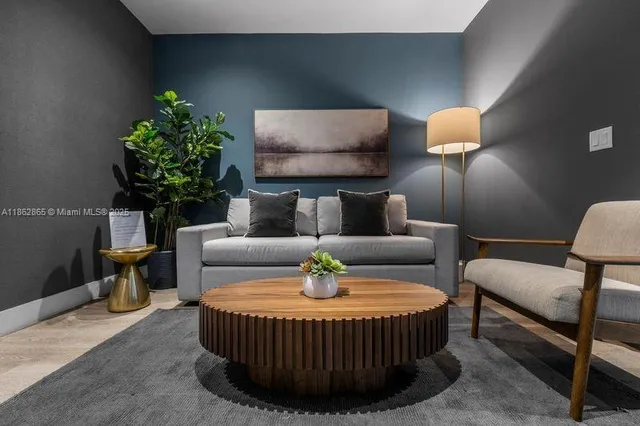 a living room with furniture and a lamp