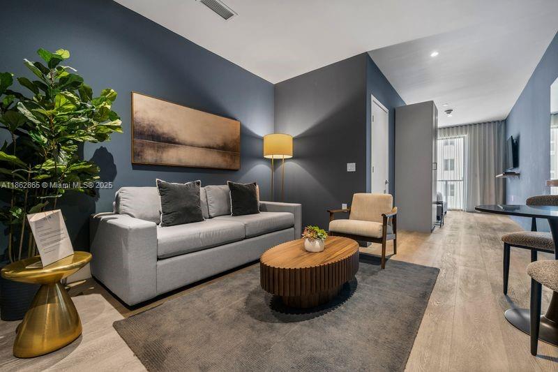 239 Southwest 9th Street, Unit 602 Miami, FL 33130 - Photo 3 of 18 a living room with furniture and a potted plant