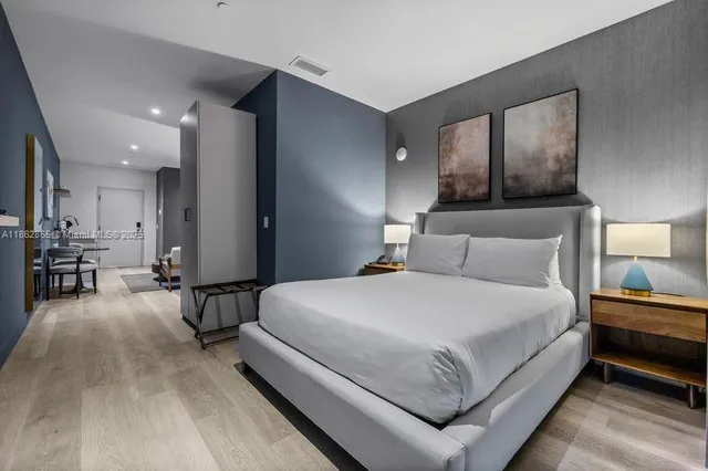 a bedroom with a bed and a table