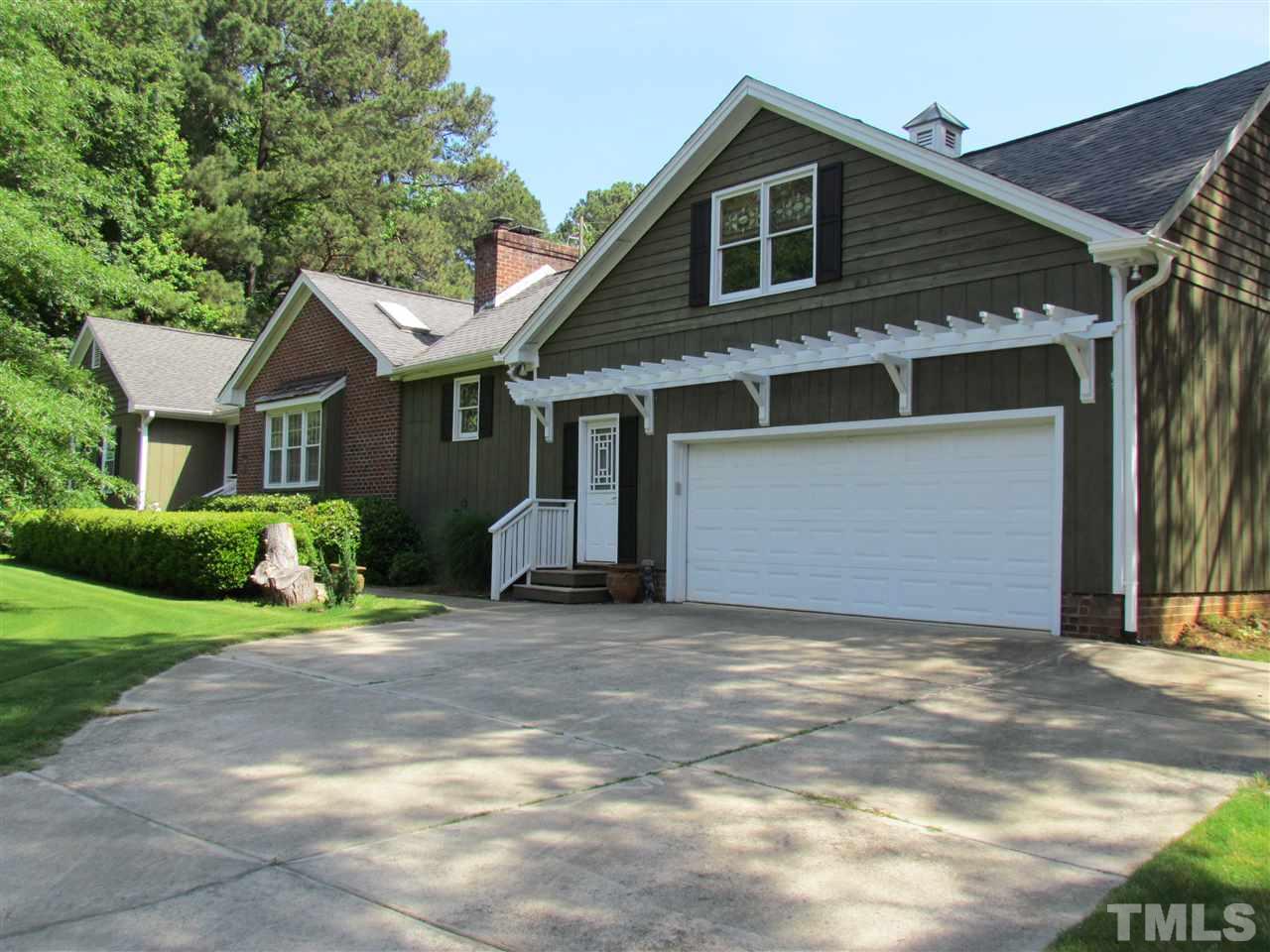 8412 Two Courts Drive Raleigh, NC 27613 - Photo 1 of 25 a view of a house with a yard and garage