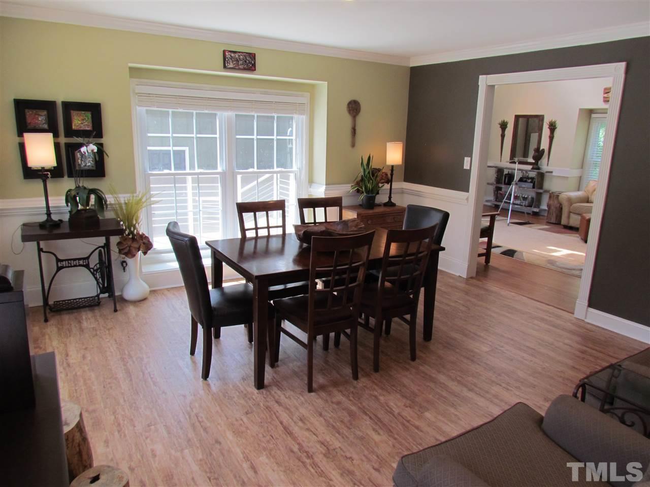 8412 Two Courts Drive Raleigh, NC 27613 - Photo 13 of 25 a view of a dining room with furniture and wooden floor
