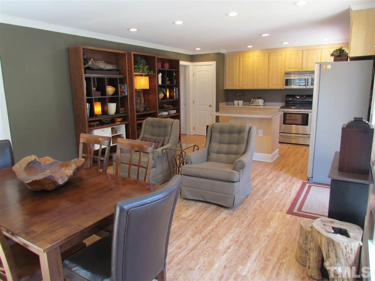 8412 Two Courts Drive Raleigh, NC 27613 - Photo 14 of 25 a living room with couches kitchen view and a refrigerator