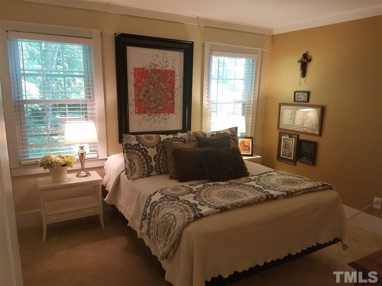 8412 Two Courts Drive Raleigh, NC 27613 - Photo 15 of 25 a bed sitting in a bedroom next to a window