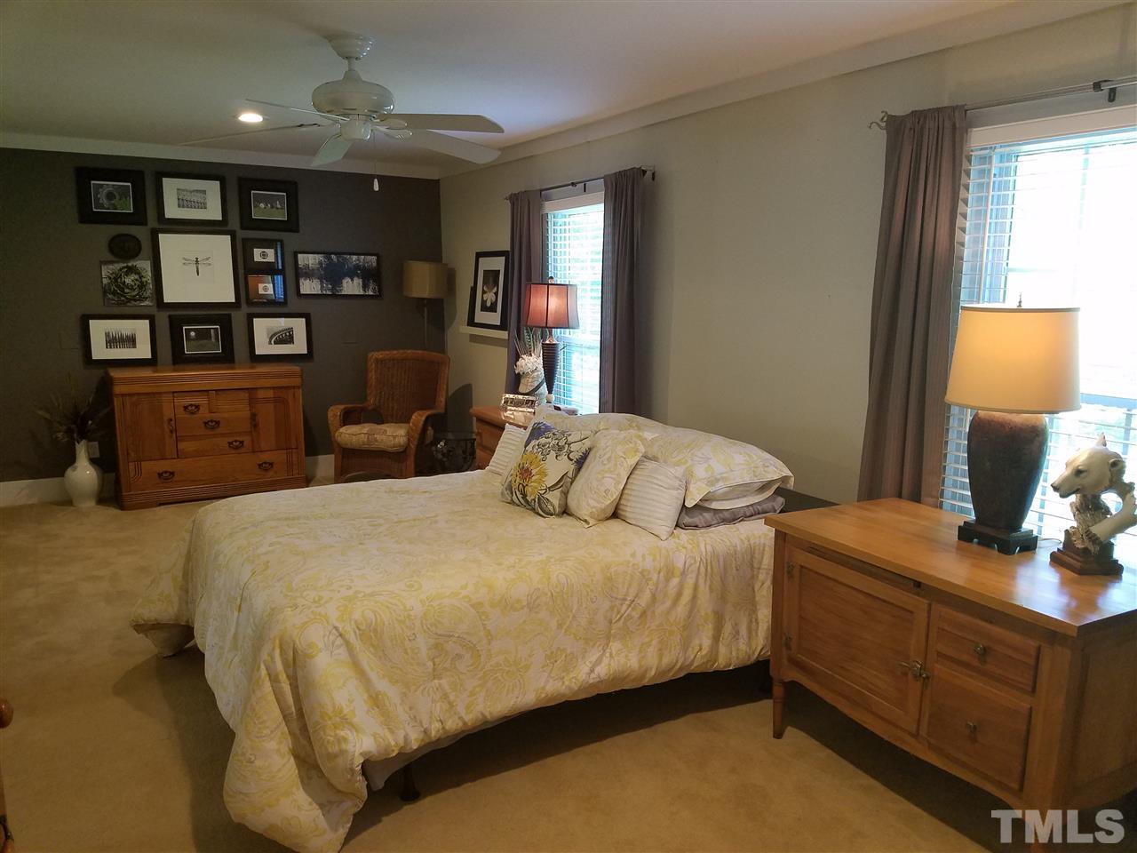 8412 Two Courts Drive Raleigh, NC 27613 - Photo 16 of 25 a bedroom with a bed window and dresser