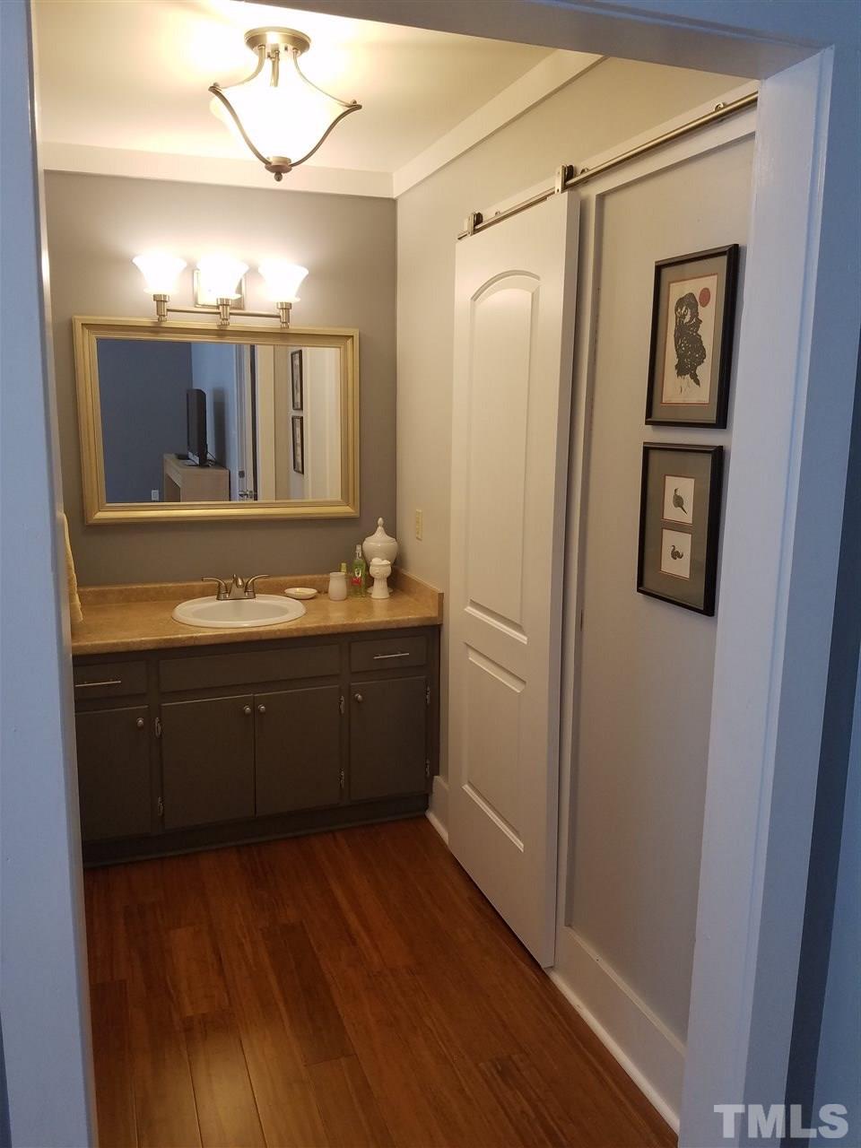 8412 Two Courts Drive Raleigh, NC 27613 - Photo 20 of 25 a bathroom with a sink and a mirror