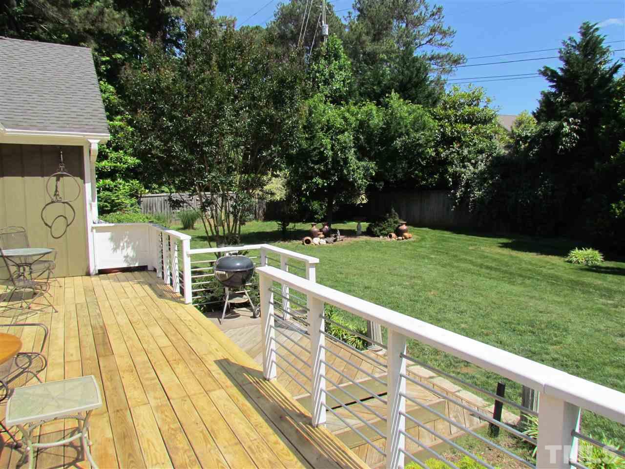 8412 Two Courts Drive Raleigh, NC 27613 - Photo 21 of 25 a view of a patio with a table chairs and a fireplace