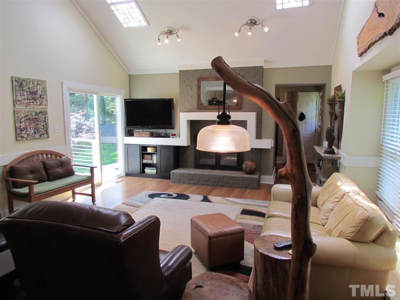 8412 Two Courts Drive Raleigh, NC 27613 - Photo 7 of 25 a living room with furniture and a flat screen tv