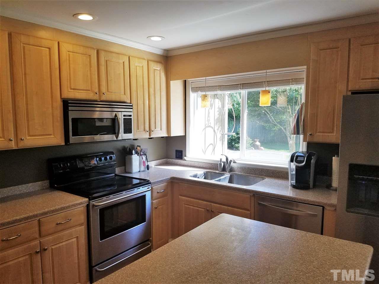 8412 Two Courts Drive Raleigh, NC 27613 - Photo 10 of 25 a kitchen with stainless steel appliances a stove sink and microwave