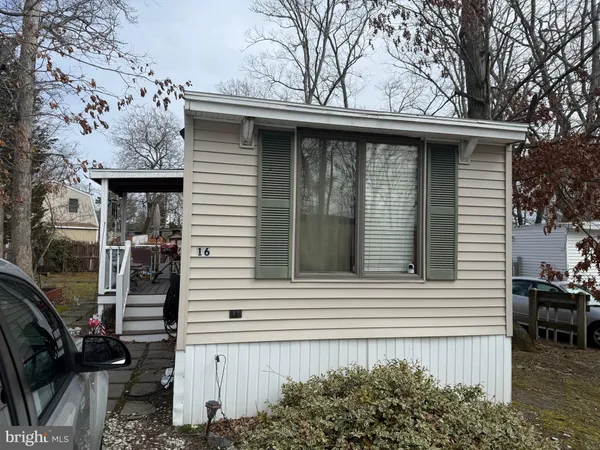 a view of a house with a door and a tree