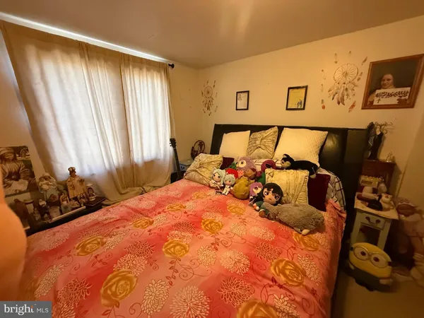 a bed sitting in a bedroom next to a window