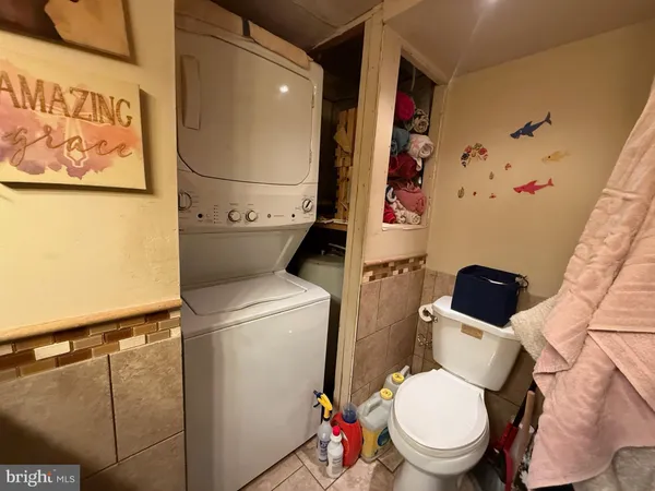 a white toilet sitting next to a bathroom sink and vanity