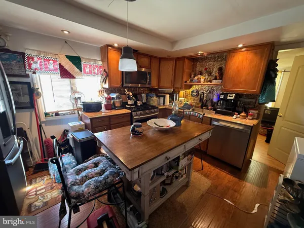a living room with furniture a flat screen tv and a dining table