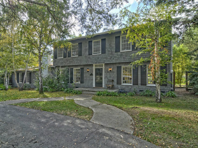 a view of a brick house with a yard
