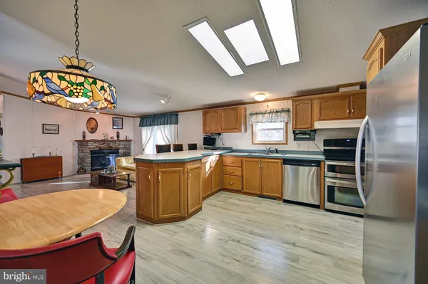 a kitchen with stainless steel appliances granite countertop a stove a sink dishwasher and a refrigerator