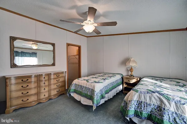 a bedroom with two beds and a dresser