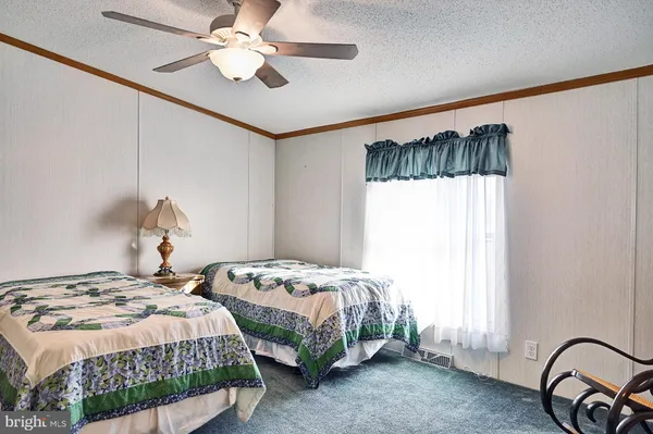 a bedroom with bed and a window