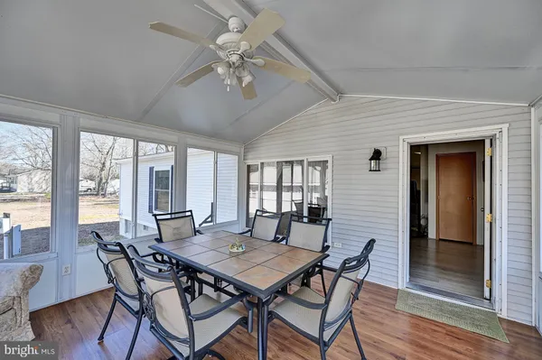 a view of a dining room with furniture wooden floor and chandelier