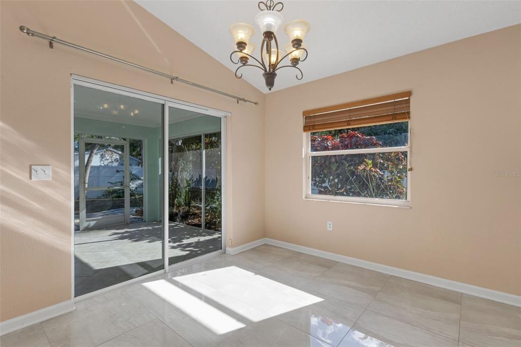 4557 Worcester Road Sarasota, FL 34231 - Photo 13 of 50 a view of a hallway with a chandelier