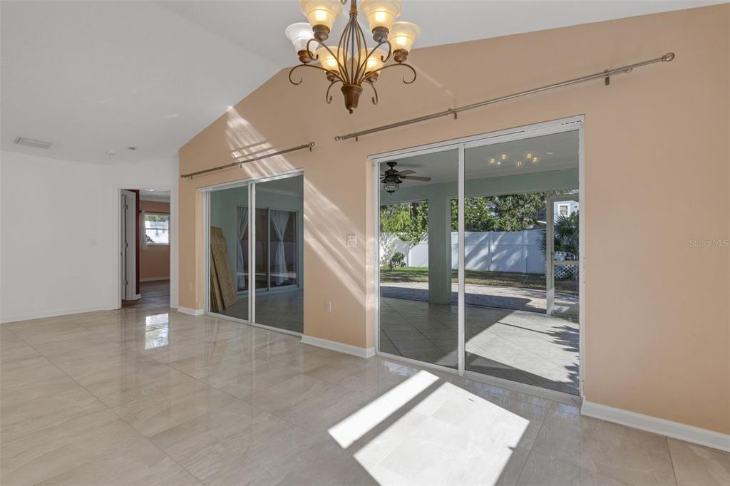 4557 Worcester Road Sarasota, FL 34231 - Photo 14 of 50 a view of a livingroom with a chandelier fan and windows