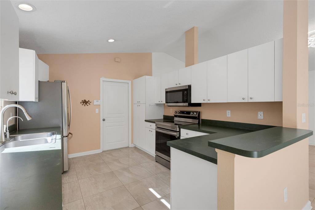 4557 Worcester Road Sarasota, FL 34231 - Photo 15 of 50 a kitchen that has a sink and a stove top oven