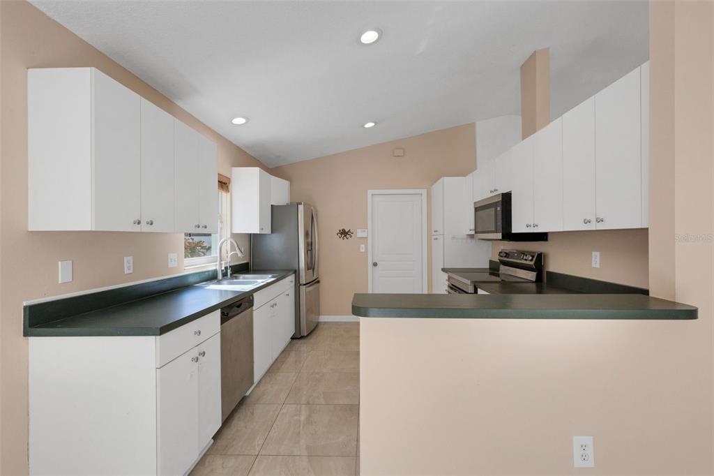 4557 Worcester Road Sarasota, FL 34231 - Photo 16 of 50 a large kitchen with stainless steel appliances lots of counter space and a sink