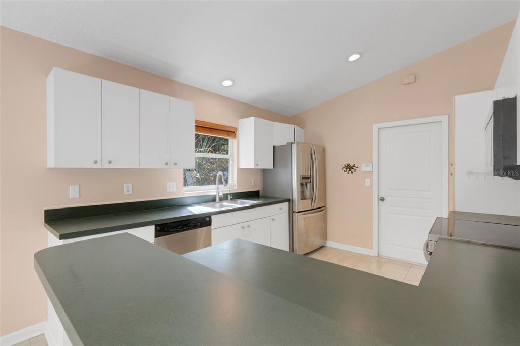 4557 Worcester Road Sarasota, FL 34231 - Photo 17 of 50 a kitchen with stainless steel appliances granite countertop a refrigerator a sink and a stove