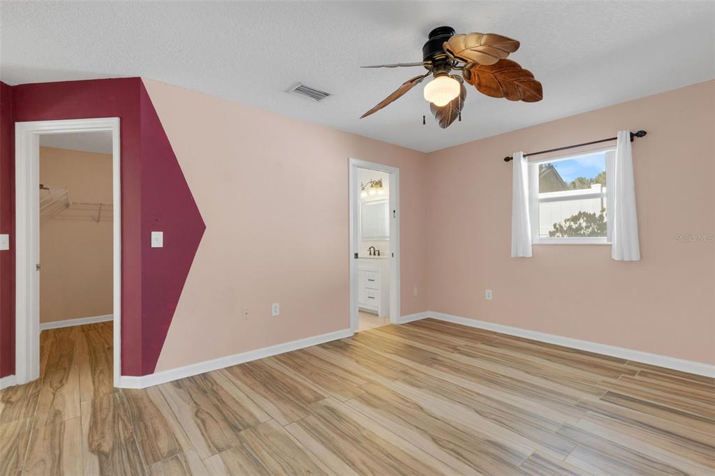 4557 Worcester Road Sarasota, FL 34231 - Photo 22 of 50 a view of an empty room with wooden floor