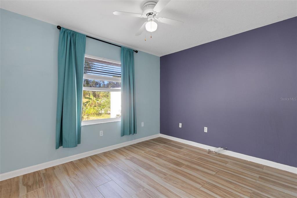 4557 Worcester Road Sarasota, FL 34231 - Photo 29 of 50 wooden floor in an empty room with a window