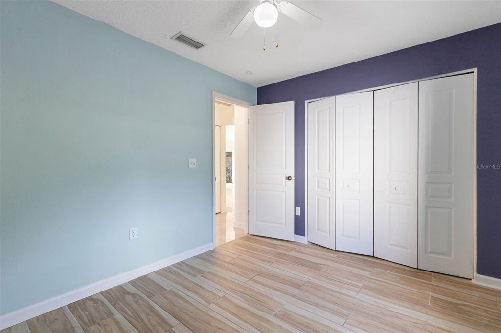 4557 Worcester Road Sarasota, FL 34231 - Photo 31 of 50 wooden floor in an empty room with a window