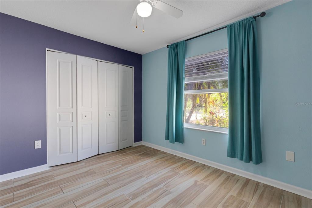4557 Worcester Road Sarasota, FL 34231 - Photo 32 of 50 a view of an empty room with wooden floor and a window
