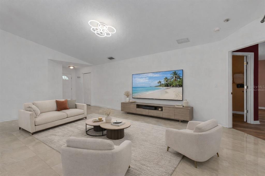 4557 Worcester Road Sarasota, FL 34231 - Photo 9 of 50 a living room with furniture and wooden floor