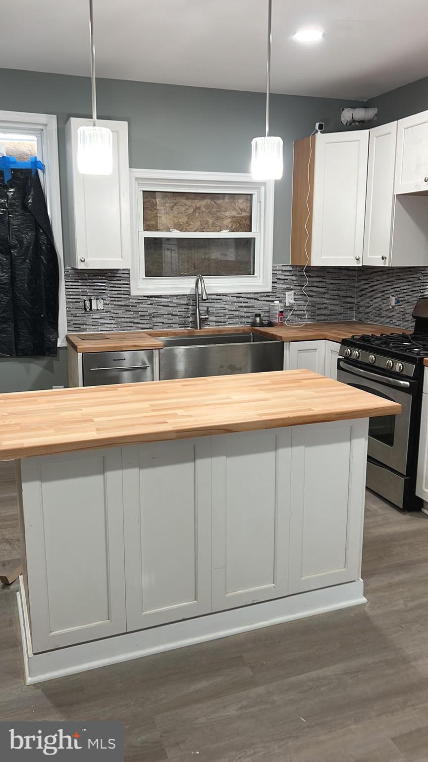 3808 Pennington Avenue Curtis Bay, MD 21226 - Photo 4 of 12 a kitchen with stainless steel appliances granite countertop a stove a sink and a microwave