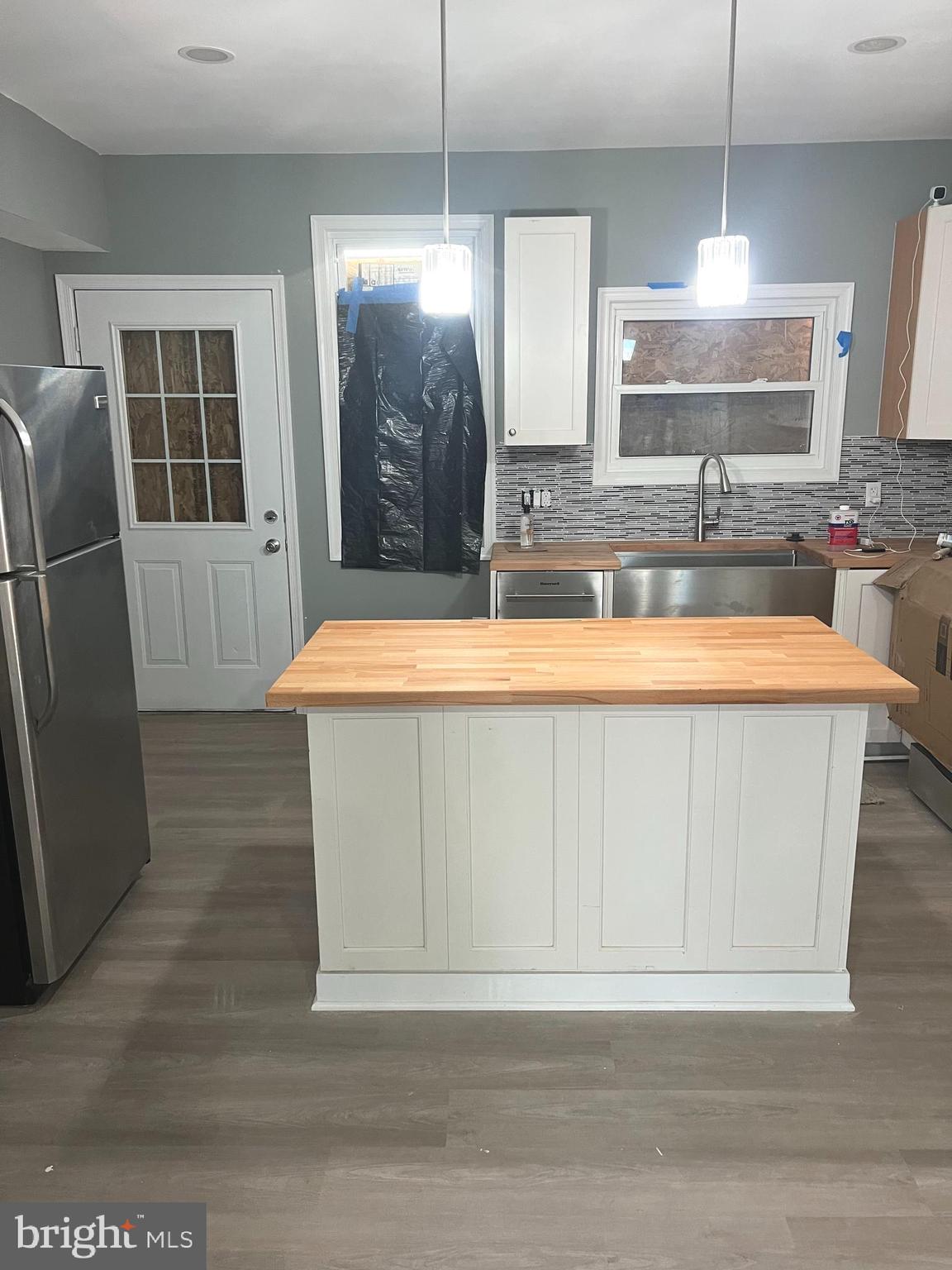 3808 Pennington Avenue Curtis Bay, MD 21226 - Photo 5 of 12 a room with stainless steel appliances kitchen island granite countertop a refrigerator a sink a washer and dryer