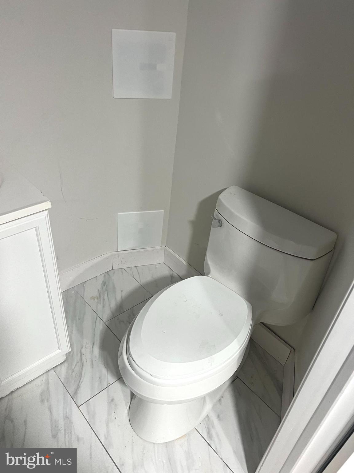 3808 Pennington Avenue Curtis Bay, MD 21226 - Photo 9 of 12 a white toilet sitting next to a bathroom sink