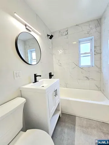 a bathroom with a sink a toilet and a bathtub