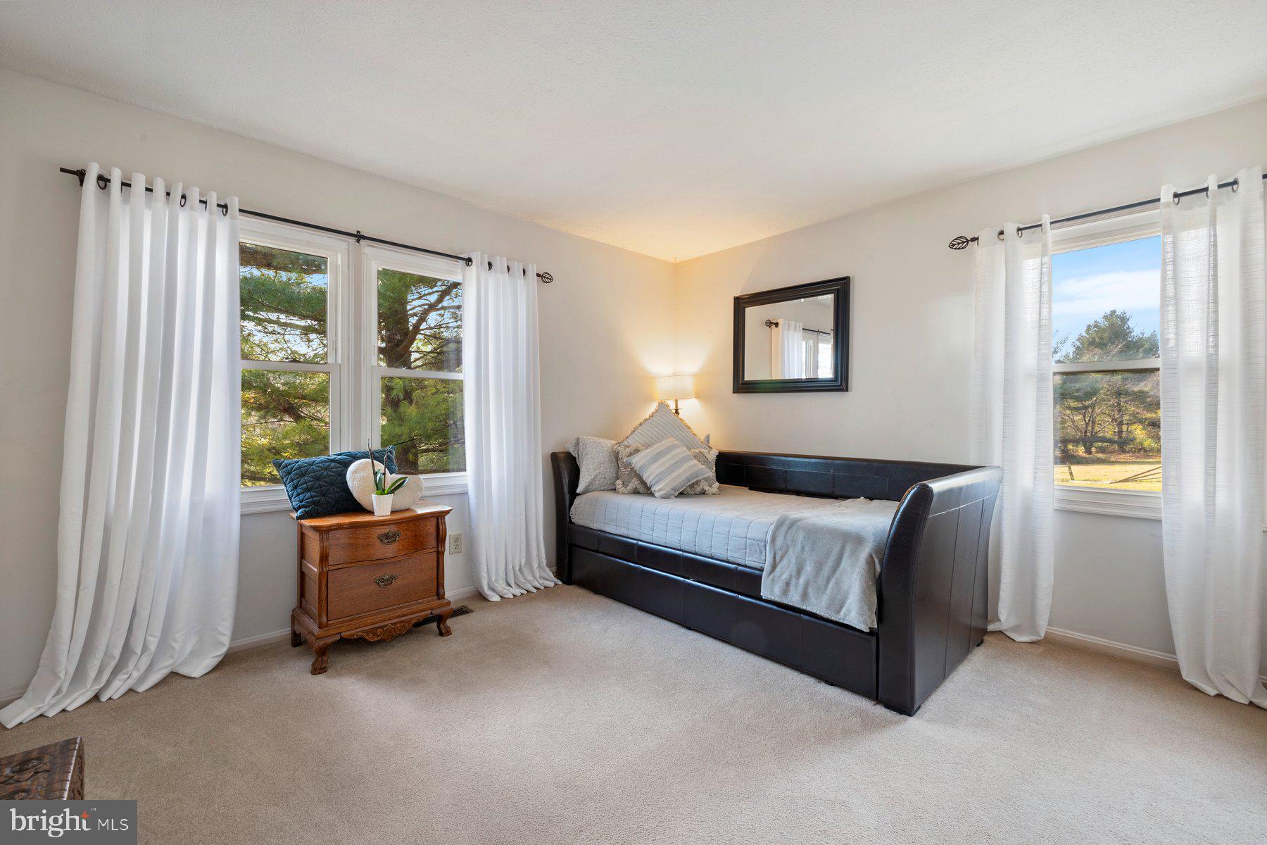 5130 Perry Road Mount Airy, MD 21771 - Photo 15 of 46 a spacious bedroom with a bed and a couch